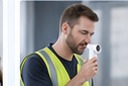 A worker performing a respiratory test at an occupational health check